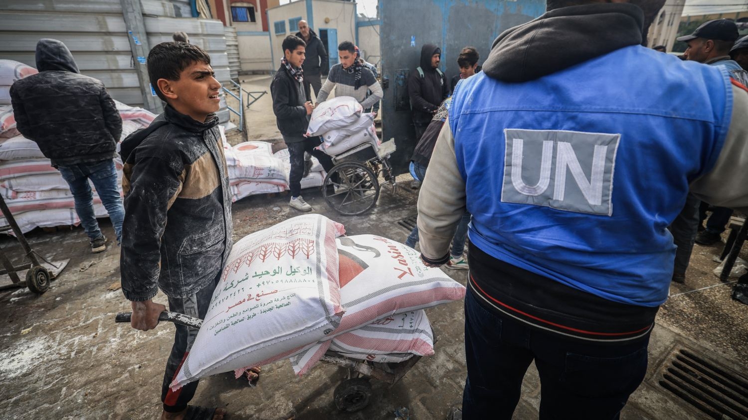 Displaced Palestinians receive food aid at the United Nations Relief and Works Agency for Palestine Refugees (Unrwa) centre in Rafah in the southern Gaza Strip on 28 January 2024.