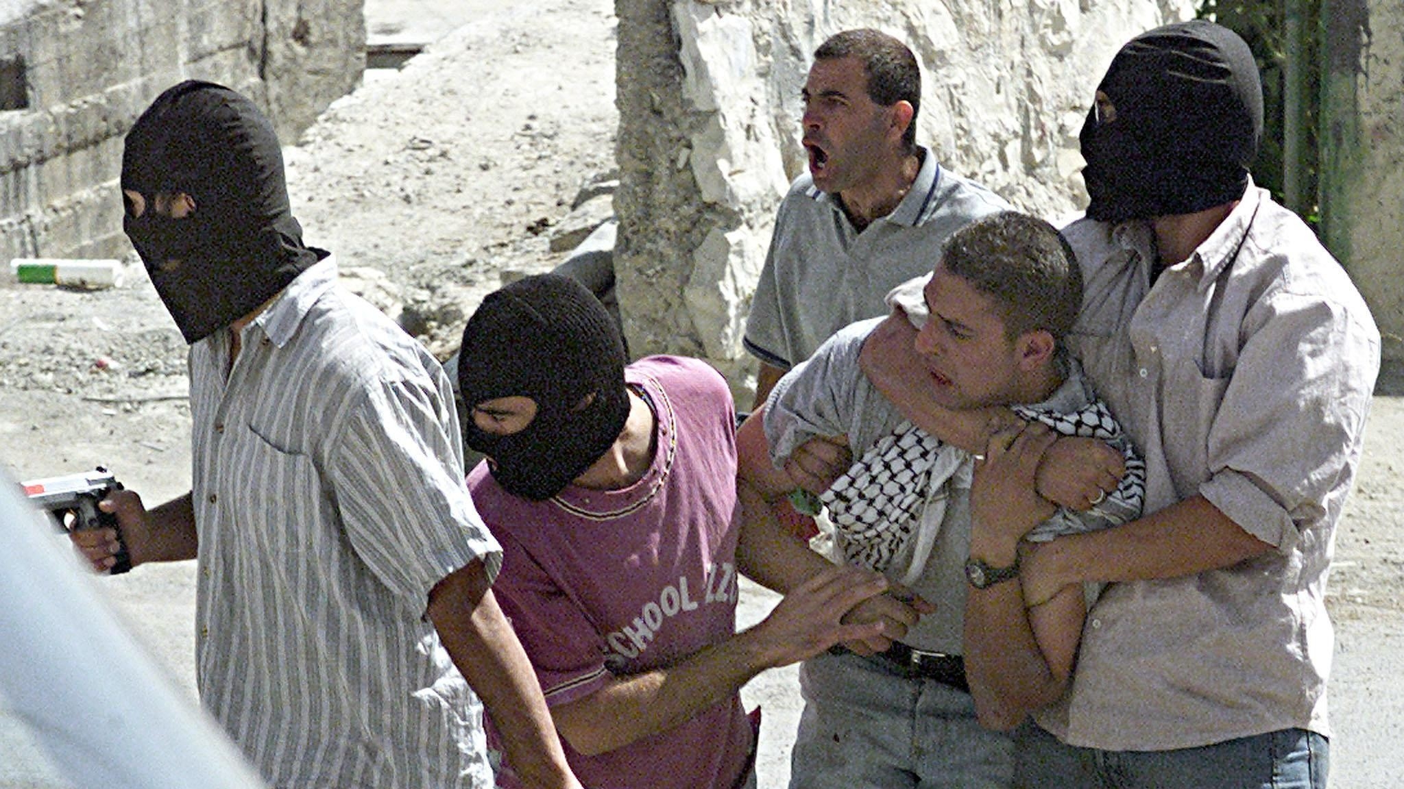 Israeli undercover police arrest a Palestinian protester in the occupied East Jerusalem neighbourhood of Jabal Mukaber on 4 October 2000 (AFP)