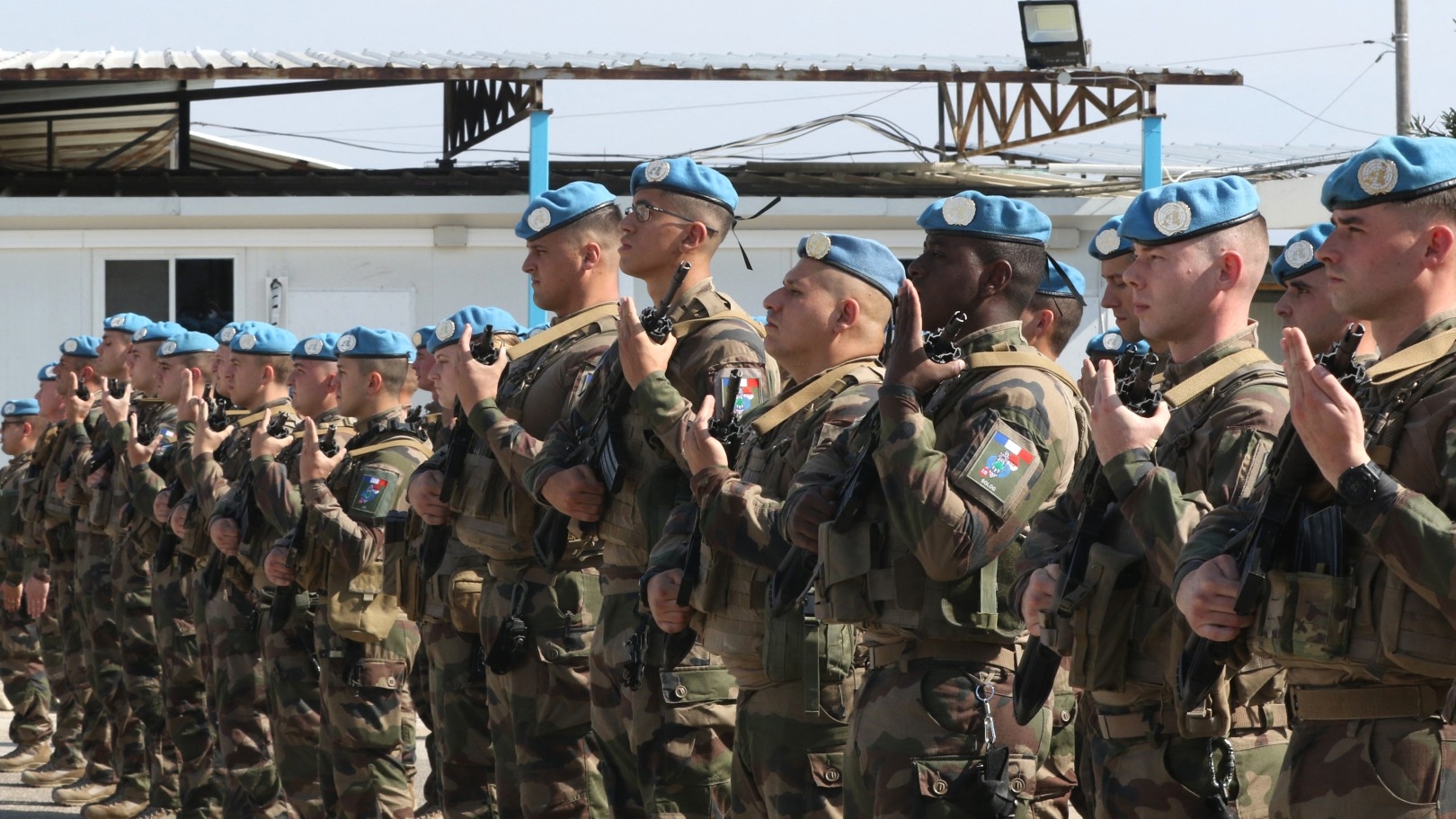 Members of the French contingent of Unifil stand at attention during a visit by the French minister of the armed forces in the southern Lebanese village of Deir Kifa on 2 November 2023 (AFP)