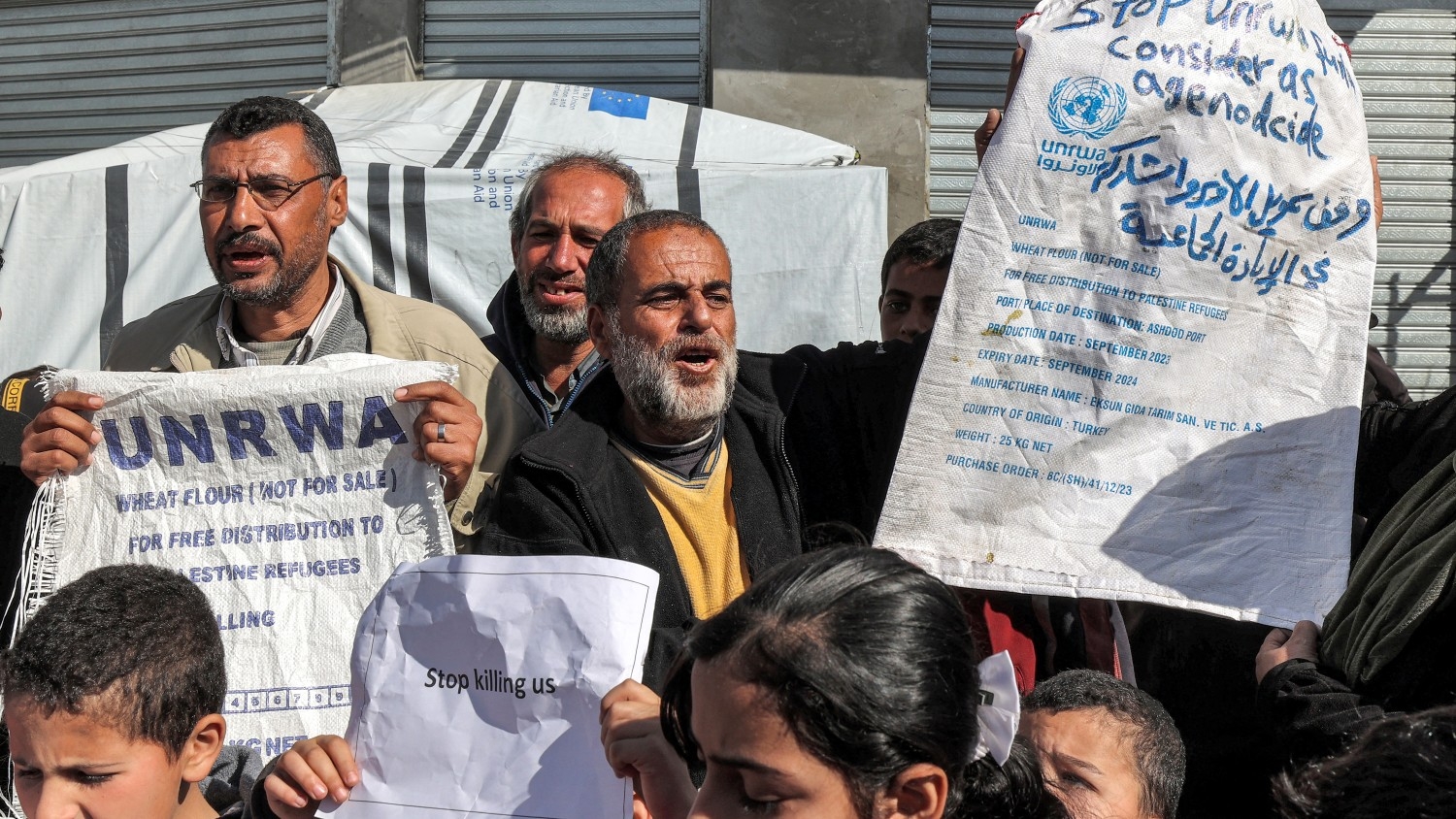 Palestinian men and children gather for a demonstration in Rafah in southern Gaza on 30 January 2024, calling for continued international support to Unrwa.