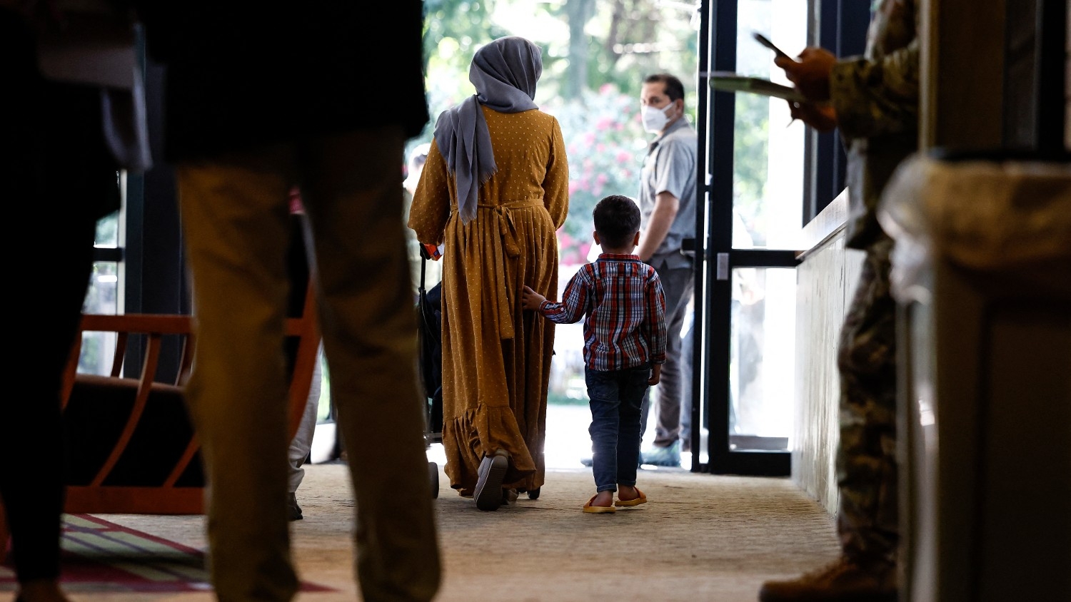 An Afghan national and her son walk through temporarily housing for Afghan nationals on 11 August 2022 in Leesburg, Virginia.