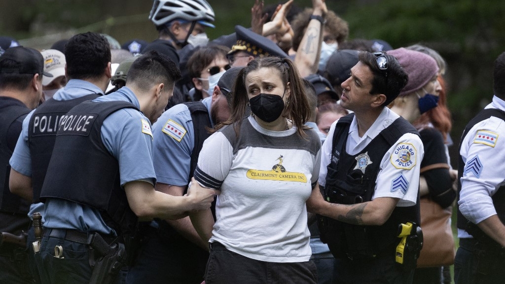 Police take demonstrators into custody on the campus of the Art Institute of Chicago after students established a pro-Palestinian protest encampment, on 4 May 2024 (Scott Olson/Getty Images/AFP)