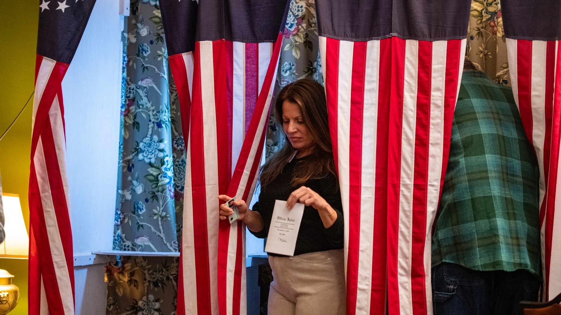 Residents of Dixville Notch, New Hampshire, cast their ballots in the US election on 5 November 2024 (Joseph Prezioso/AFP)