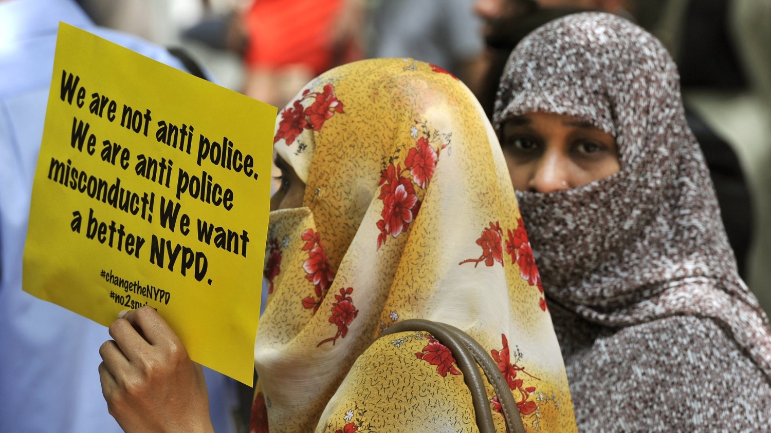 Muslim women hold a sign during a press conference on 18 June 2013 in New York to discuss planned legal action challenging the city police department's surveillance of businesses frequented by Muslims.