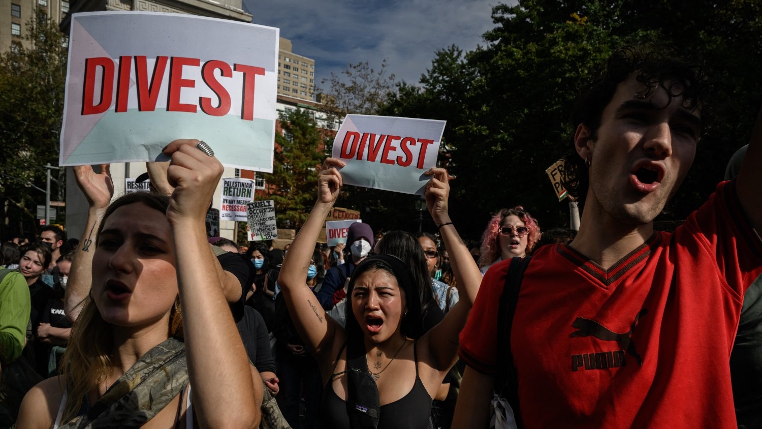 New York University students hold "Divest" sign as they participate in a walkout during a national day of action called by the "Students for Justice in Palestine"in New York on 25 October 2023.
