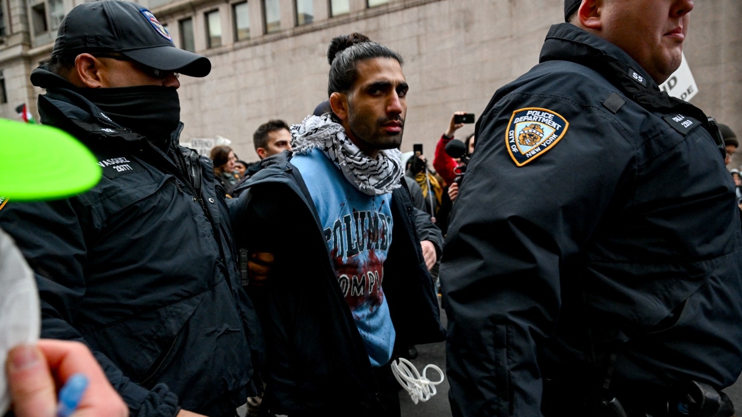 An arrested pro-Palestine protestor is led away with the NYPD during demonstrations near Columbia University on 2 February 2024 in New York City.