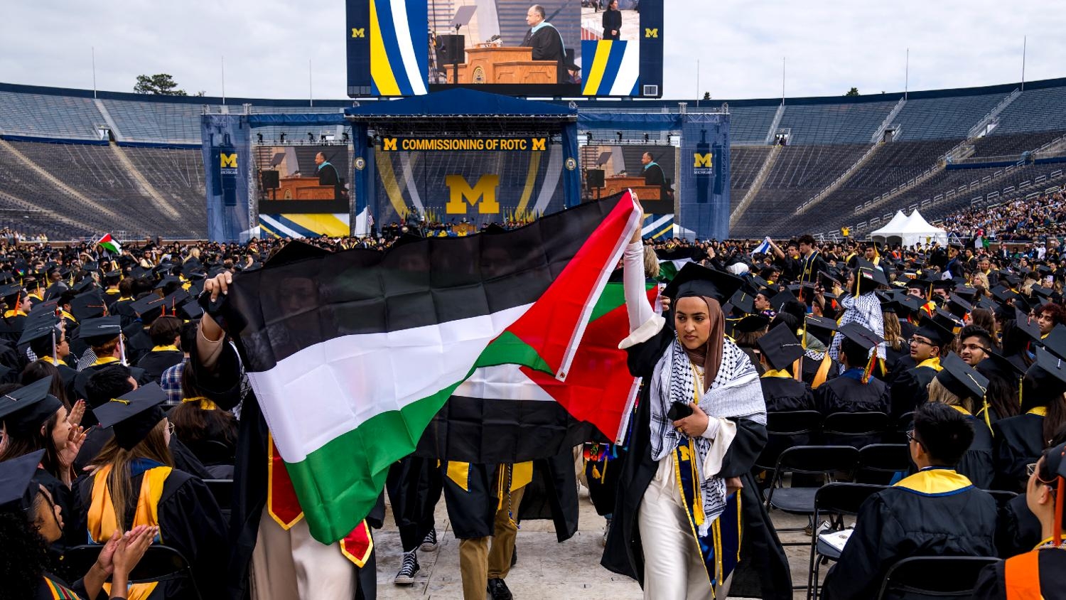 Salma Hamamy carries a flag of Palestine during a pro-Palestinian protest during the University of Michigan's spring commencement ceremony on 4 May 2024 at Michigan Stadium in Ann Arbor, Michigan.