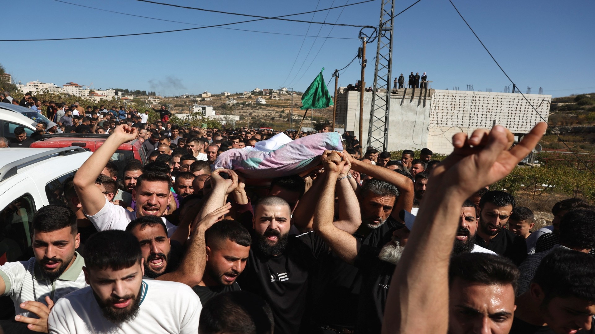 Mourners carry the body of Palestinian youth Mahmoud Atrash who was killed in an Israeli raid near Hebron on 6 November (Reuters)