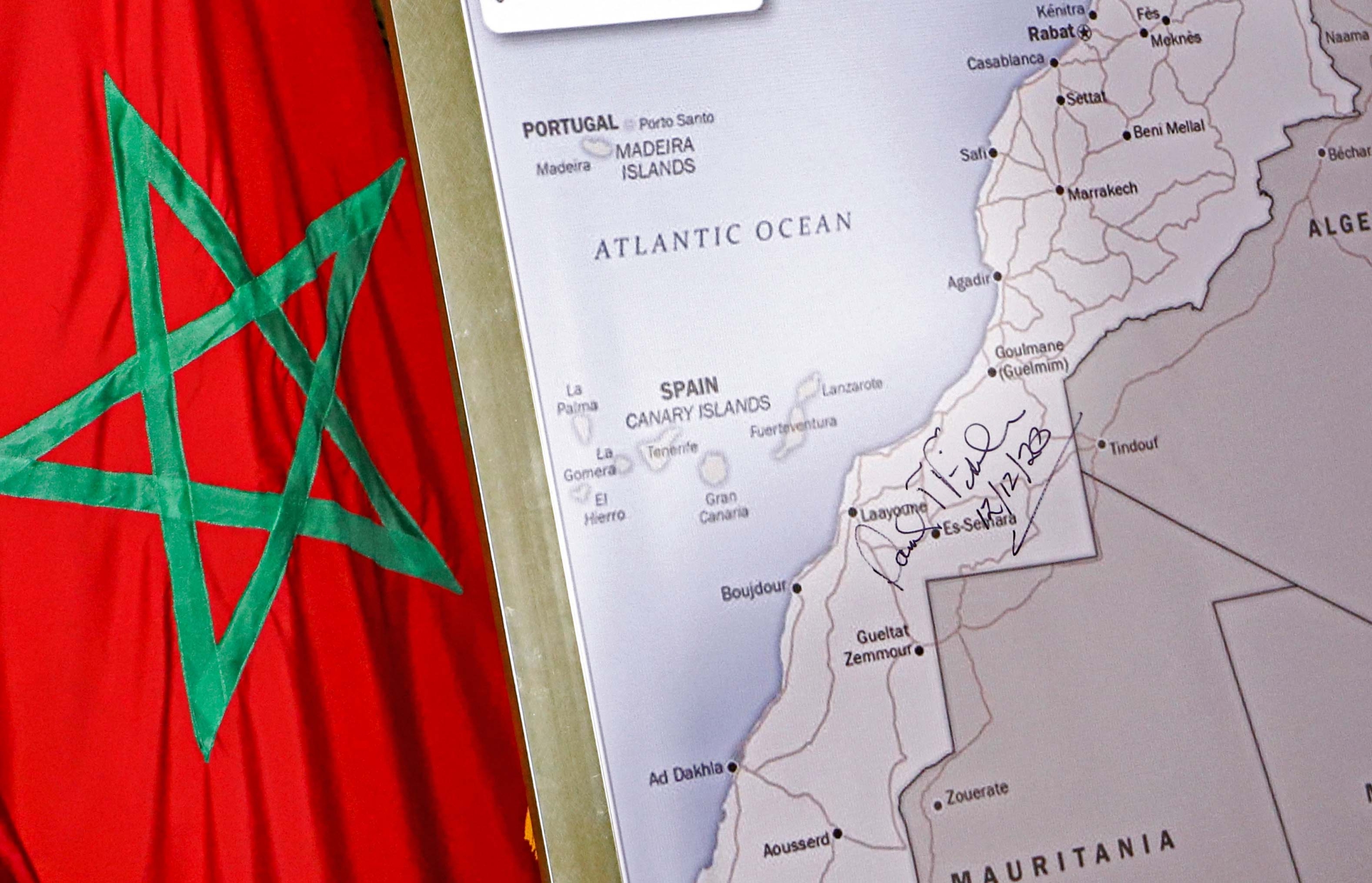 The Moroccan flag is shown next to a US State Department-authorised map of Morocco recognising the territory of the Western Sahara as a part of the North African kingdom.