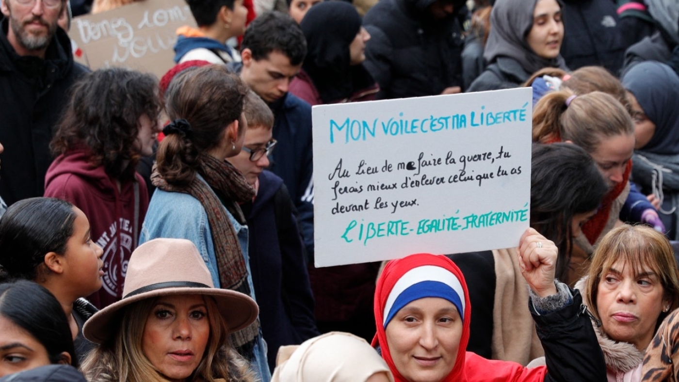 A woman holds a placard reading "My veil is my freedom" as she takes part in a demonstration march near the Gare du Nord, in Paris to protest against Islamophobia, on 10 November 2019 (AFP)