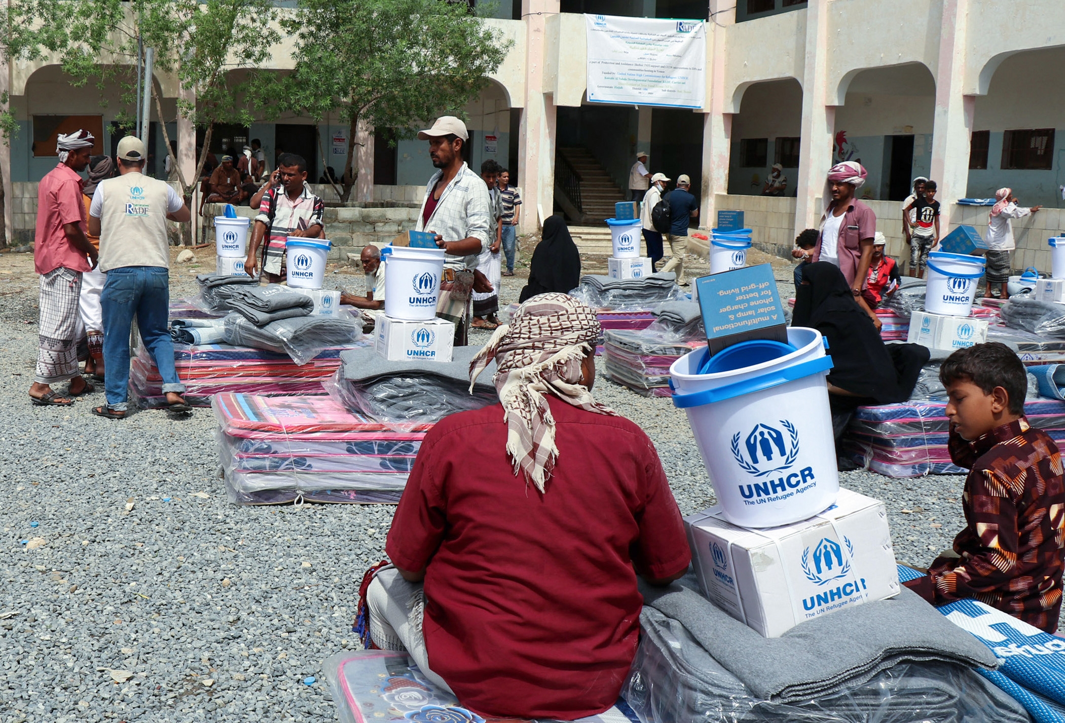 Displaced Yemenis receive humanitarian aid provided by the UN High Commissioner for Refugees in the northwestern province of Hajjah on 1 August 2021.