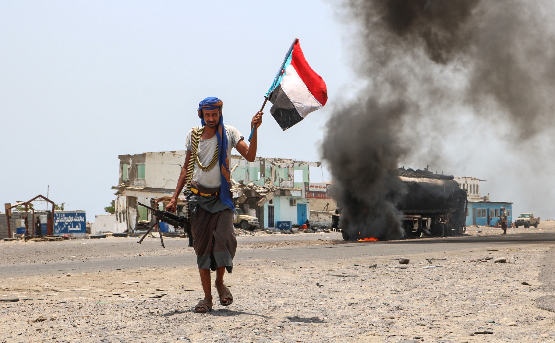 A fighter of the UAE-trained Security Belt Force walks with a separatist flag in southern Yemen (AFP/Nabil Hasan)