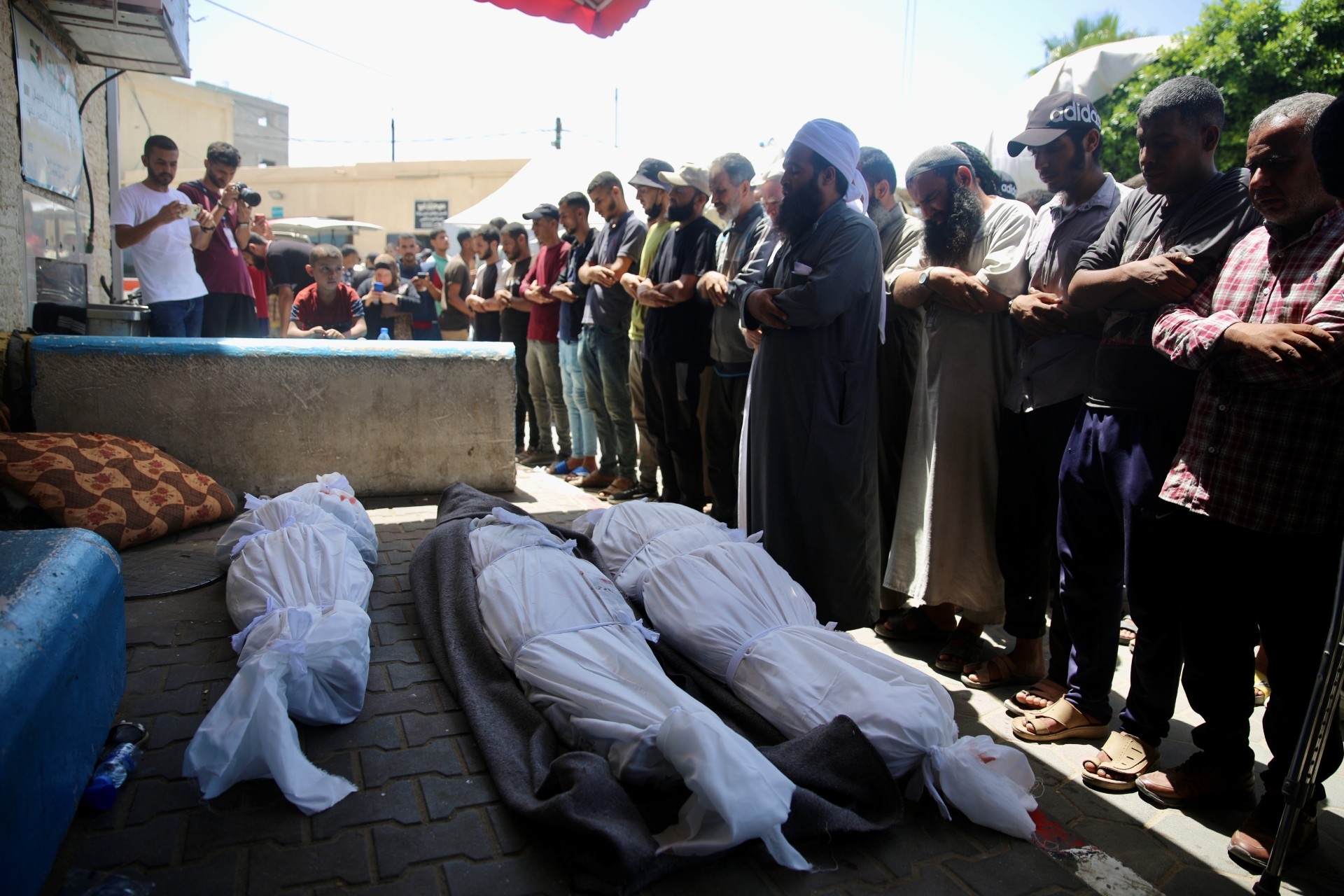 Funeral prayers are held for Palestinians killed by an Israeli attack on central Gaza (MEE/Mohammed al-Hajjar)