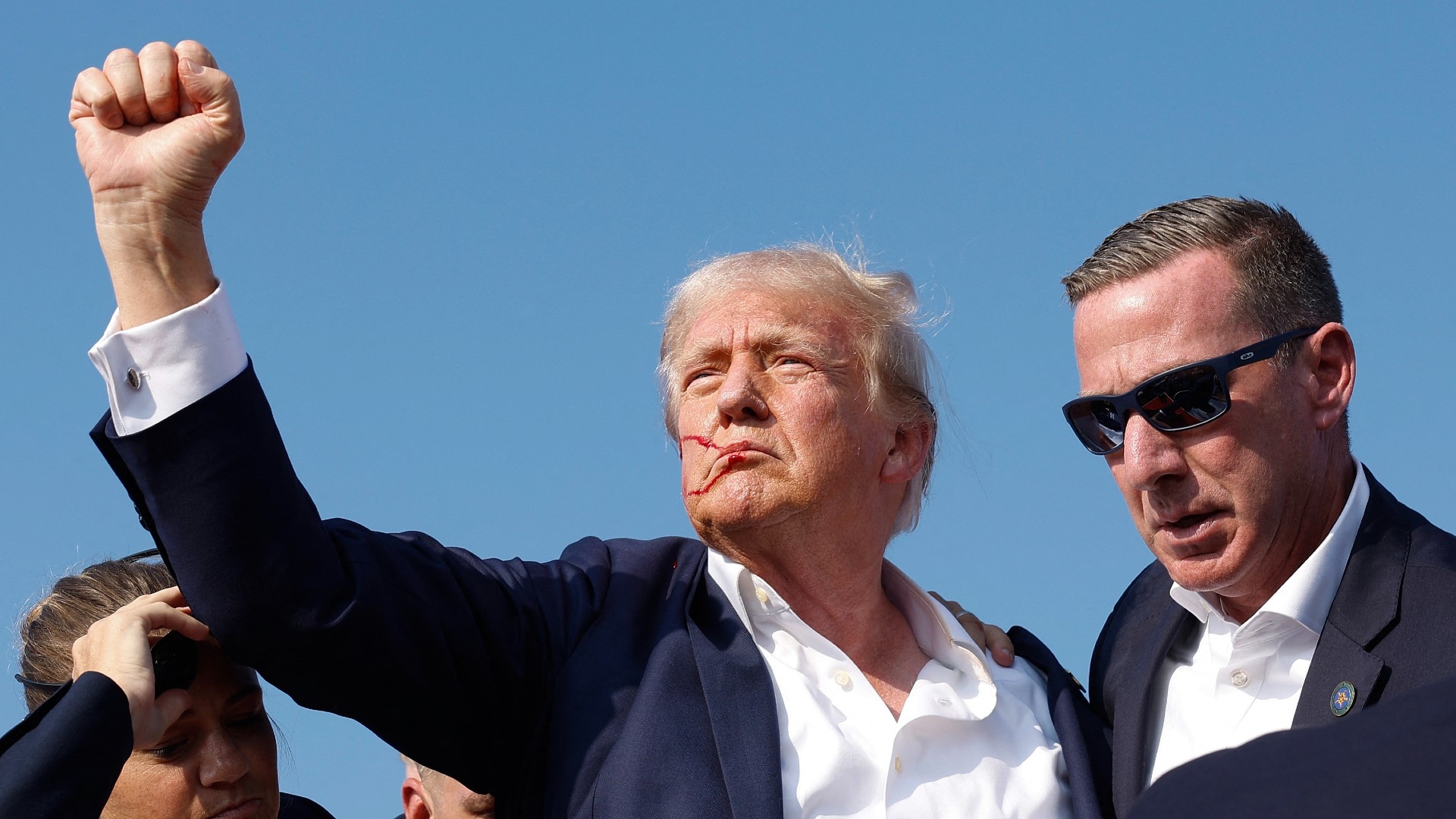 Former US President Donald Trump pumps his fist to the crowd after being shot at a campaign rally in Butler, Pennsylvania on 13 July 2024 (Anna Moneymaker/Getty Images/AFP)