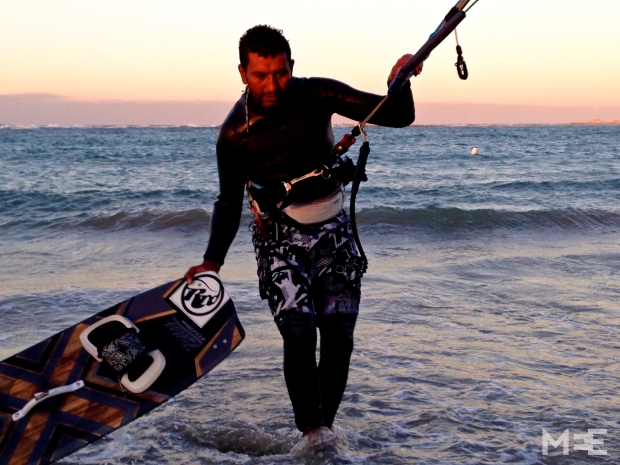 Jalal, who has helped popularise kite-surfing in Libya since the revolution, coming ashore (MEE/Tom Wescott)