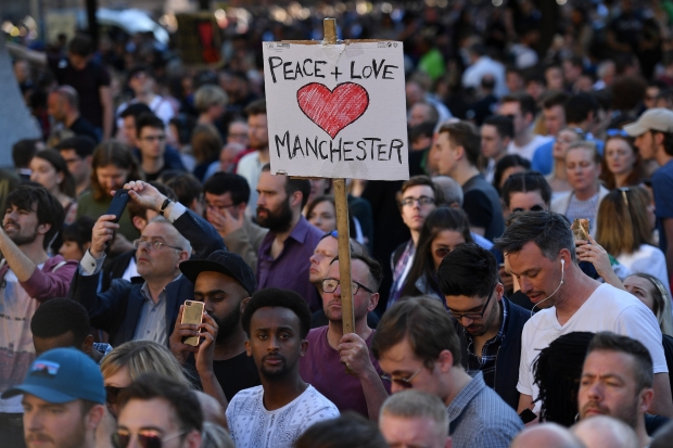 People attend a vigil in Manchester on 23 May 2017 in solidarity with victims of attack at the Manchester Arena (AFP)