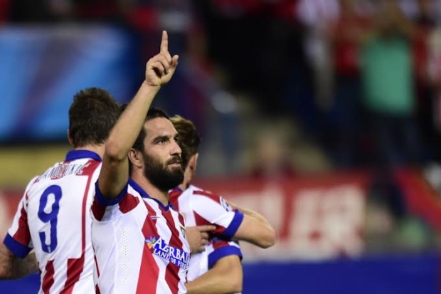 Atletico Madrid's Turkish midfielder Arda Turan celebrates after scoring the first goal during the UEFA Champions League group A football match in Madrid on 1 October, 2014 (AFP)