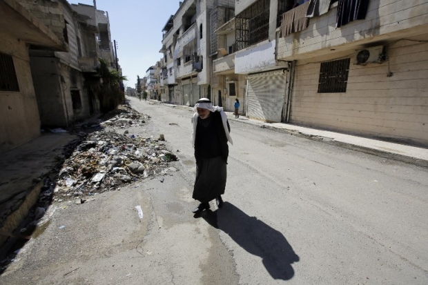 An old man amidst the ruins in Homs (AFP)