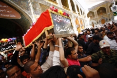 Iraqi men on Sunday carry coffin of protester killed in clash with security forces guarding Baghdad's green zone, during his funeral in Iraq's holy city of Najaf. (AFP)