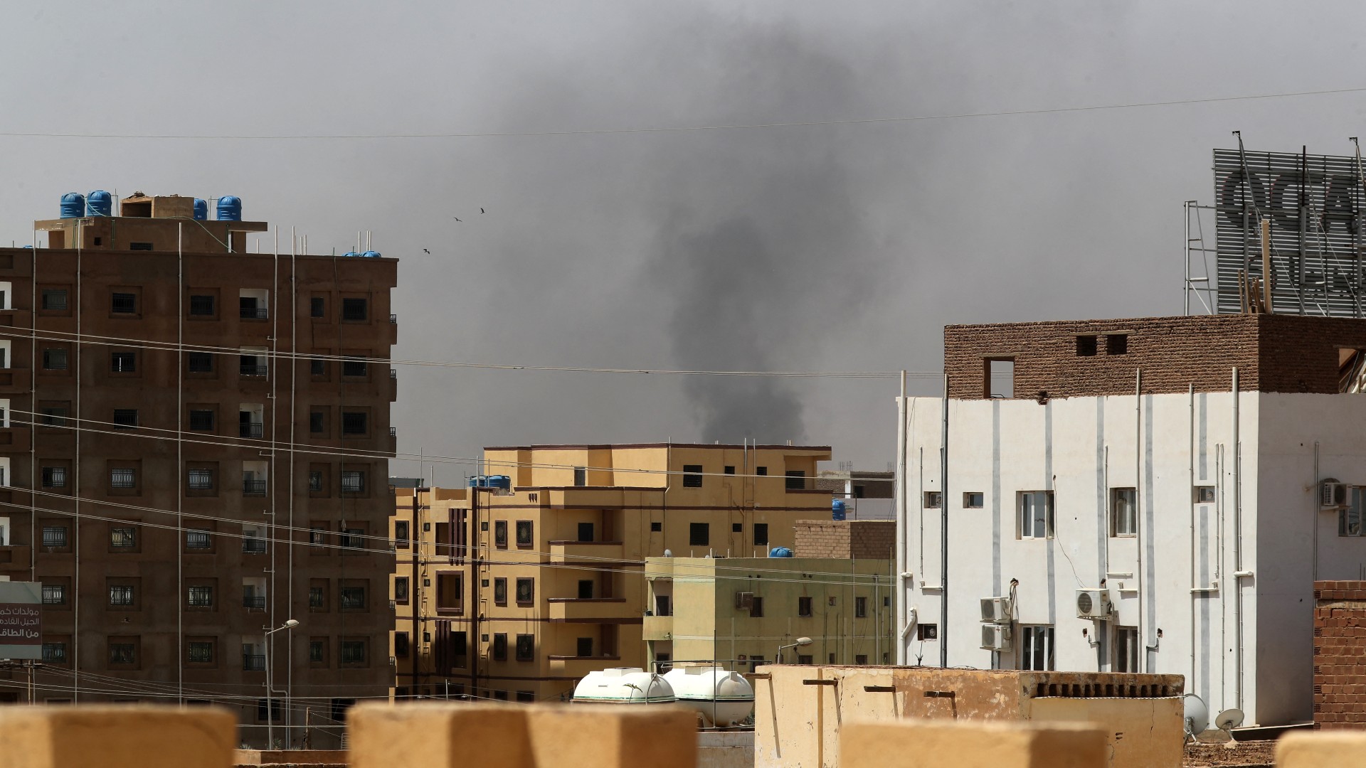 Smoke rises above buildings in Khartoum on 15 April 15, 2023, amid clashes in the city (AFP)