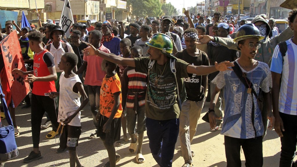 Sudanese demonstrators take to the streets of Khartoum on 13 December 2022 (AFP)