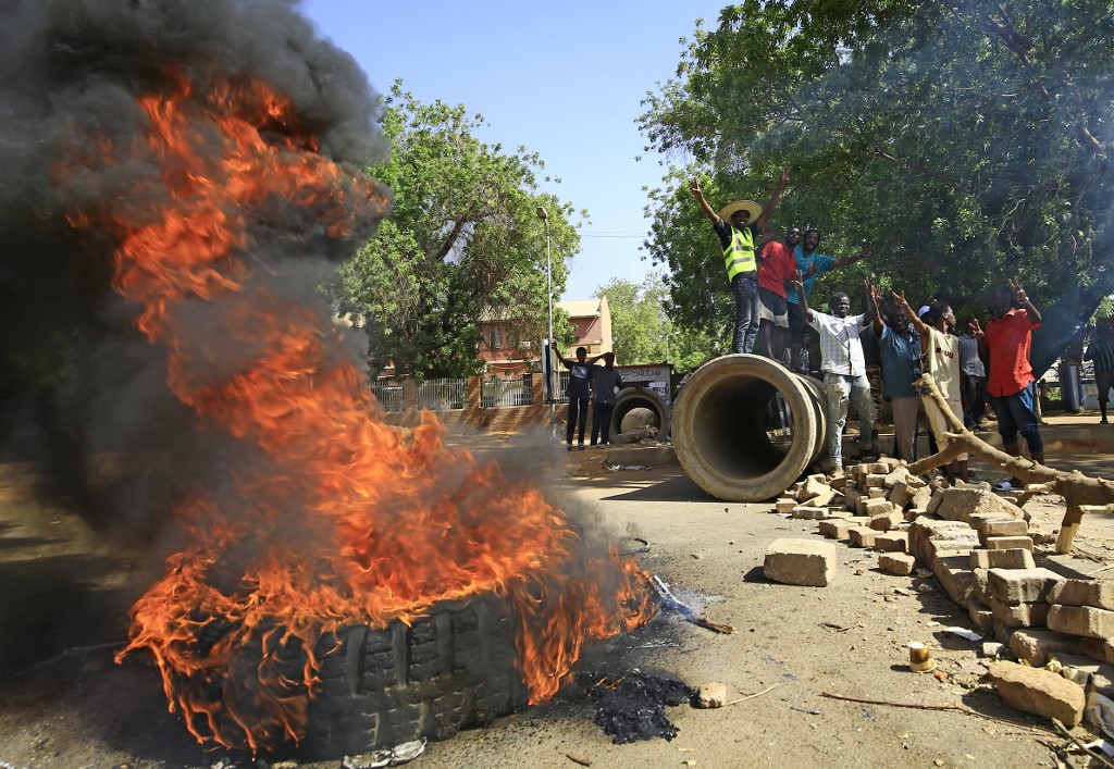Sudanese protesters burn tyres in Khartoum on 13 May (AFP)