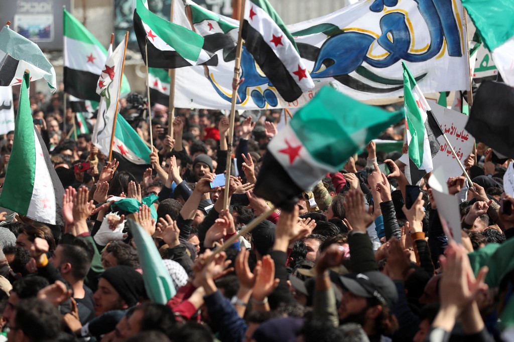 Syrians in Idlib mark 10 years since the start of the uprising on 15 March 2021 (AFP)