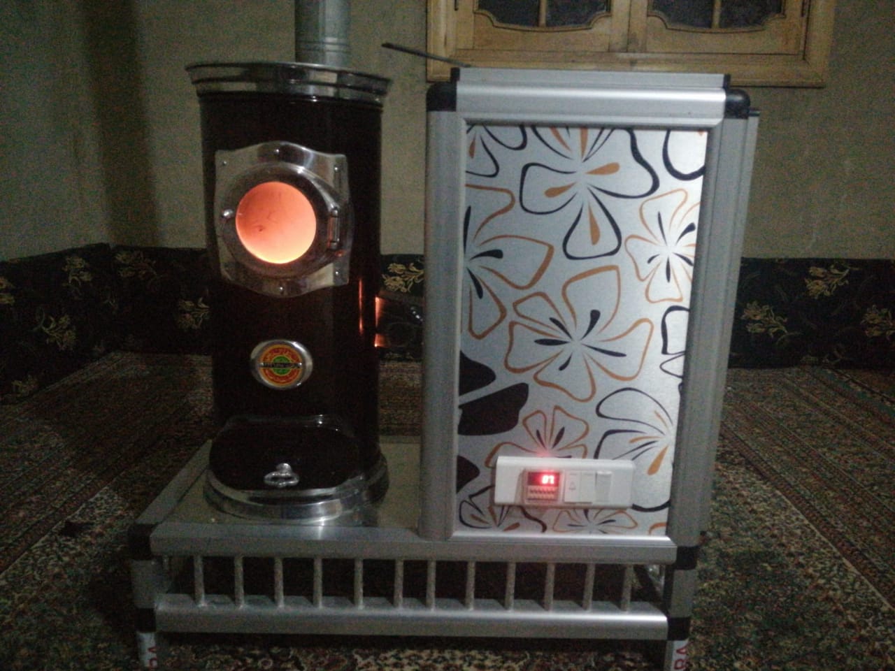Hussein Ahmed keeps his home warm by burning pistachio shells in this specialized oven (MEE/Hussein Ahmed)