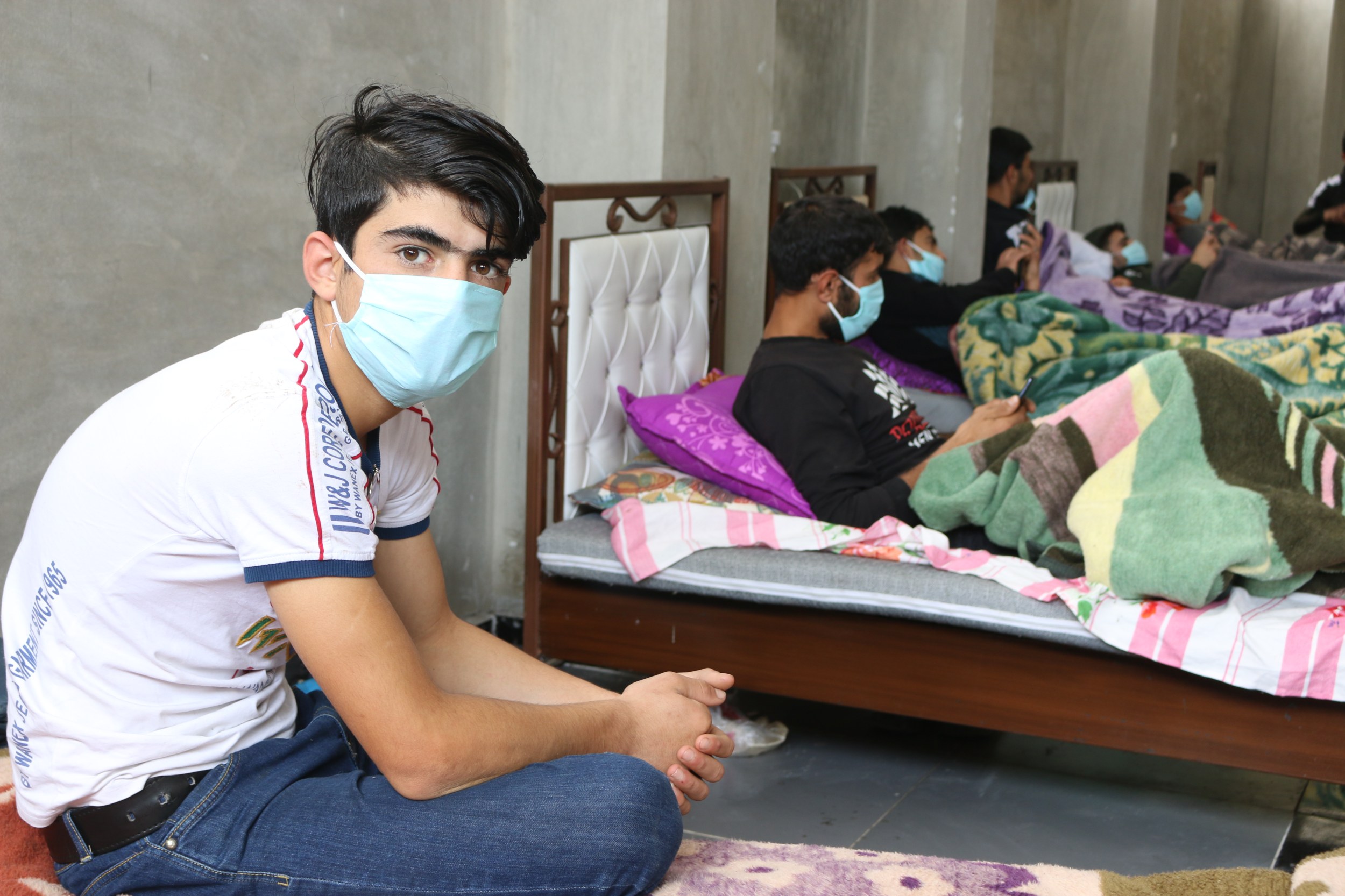 A patient at the quarantine centre looks on on 6 May 2020 (MEE/Mustafa Dahnon)