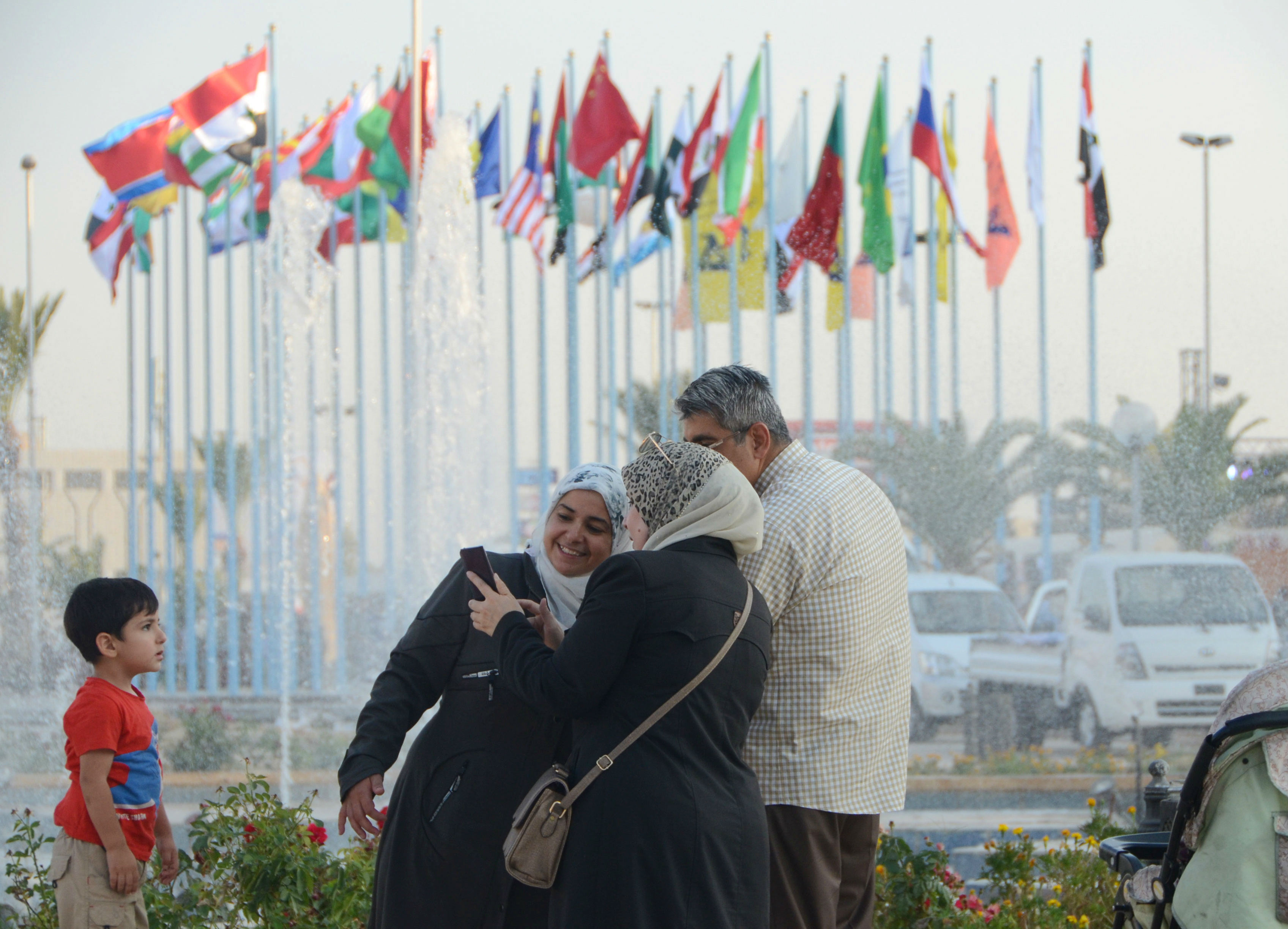 People arrive to attend the Damascus International Fair in the Syrian capital (AFP)
