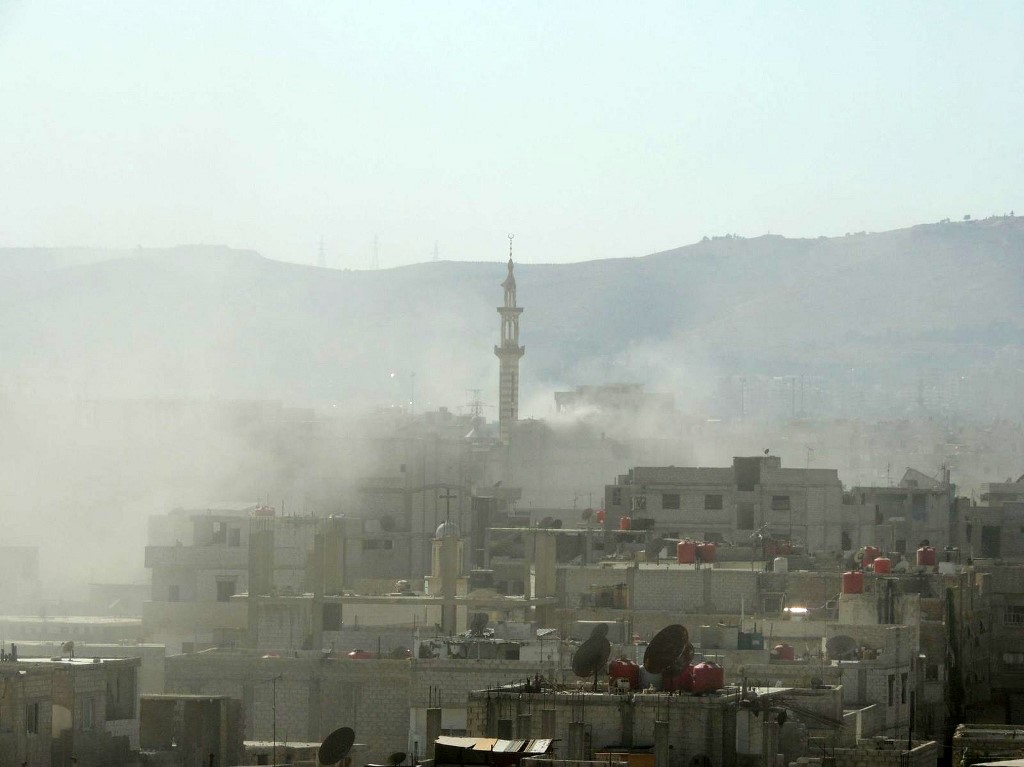 De la fumée s’élève dans la Ghouta orientale à la suite de ce que l’opposition syrienne qualifie d’attaque au gaz toxique menée par les forces pro-gouvernementales, le 21 août 2013 (photo fournie par le média de l’opposition syrienne Shaam News Network/Ammar al-Arbini/AFP)