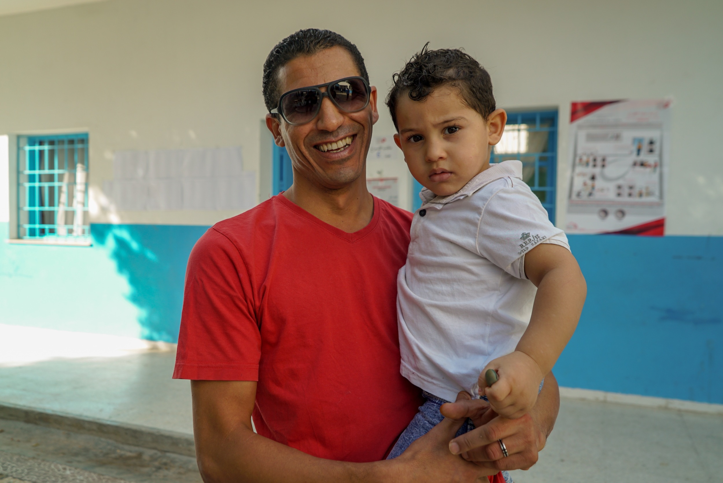 “We are hopeful that better things will come,” says Taher Weshtati, who brought his young son with him to vote (MEE/Faisal Edroos)