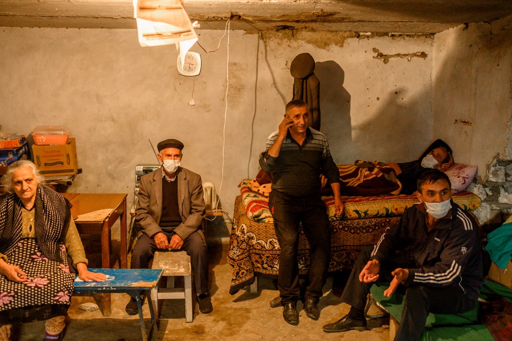 People shelter from shelling in a basement in Terter, Azerbaijan, on 13 October (AFP)