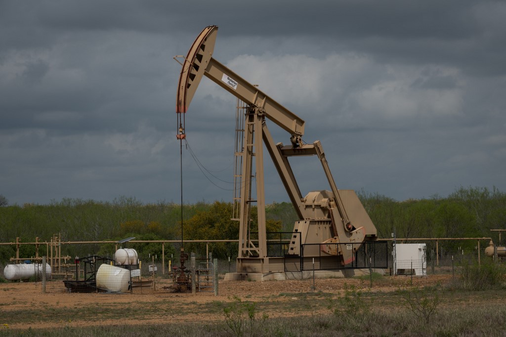 A pump jack at an oil extraction site is pictured in the US state of Texas on 12 March (AFP)