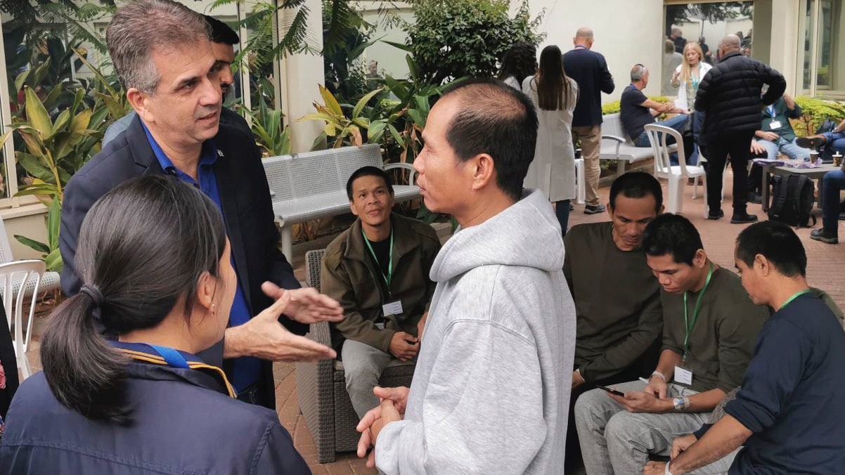 Israel's Foreign Minister Eli Cohen, left, talks to one of the freed Thai hostages at the Shamir Medical Center in Israel on 25 November 2023.