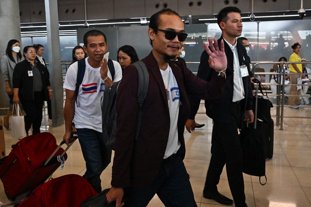 Thai national Pornsawan Pinakalo (C), who had been held captive by Hamas during the October 7 attack, arriving in Thailand on 30 November 2023 (AFP)