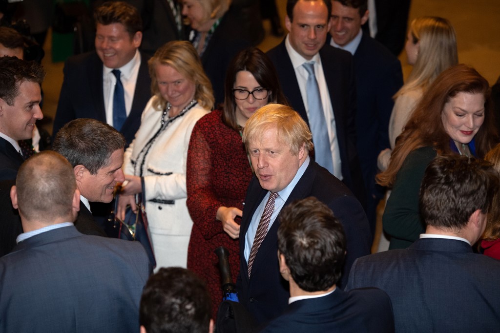 Johnson speaks with newly elected Conservative MPs in London on 16 December (AFP)