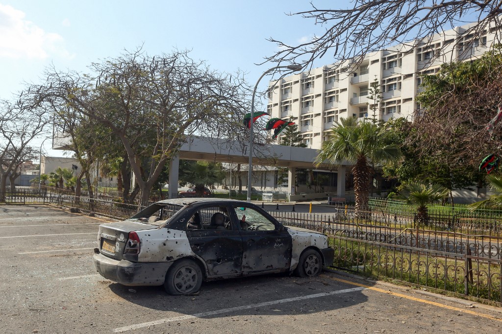 A burnt-out car is seen at the parking lot of Khadra General Hospital which is dedicated to treating people infected with coronavirus (COVID-19) in the Libyan capital Tripoli on April 8, 2020,