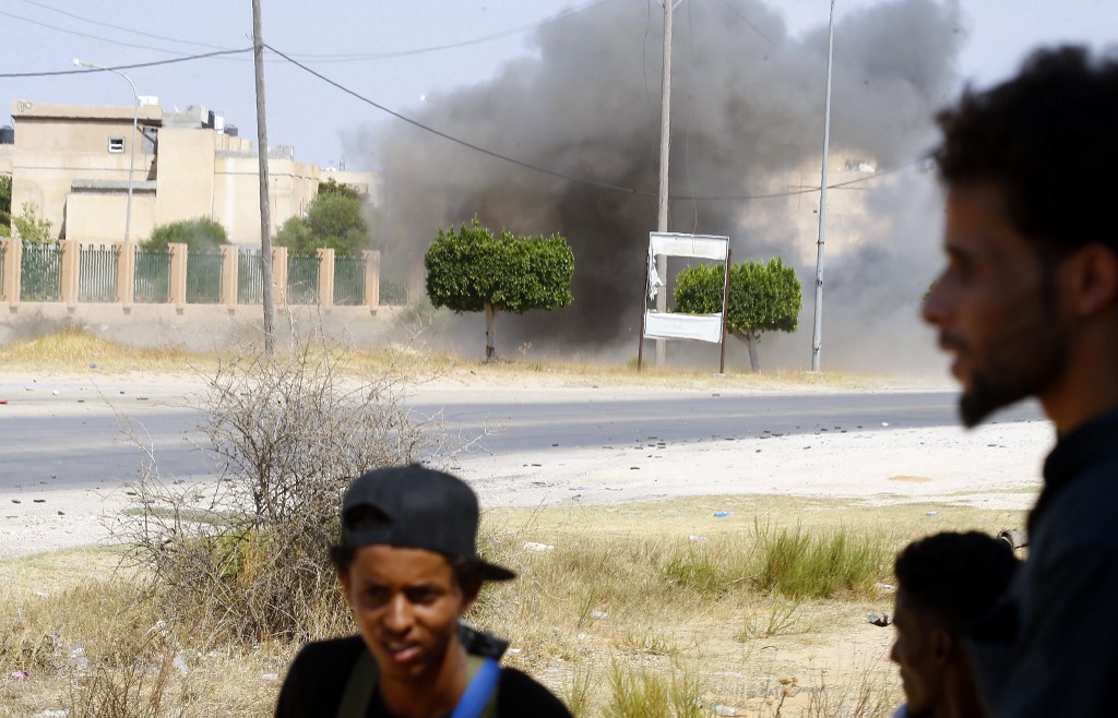 Fighters loyal to the GNA gather during clashes with forces loyal to strongman Khalifa Haftar south of the Libyan capital Tripoli on 21 August (AFP)