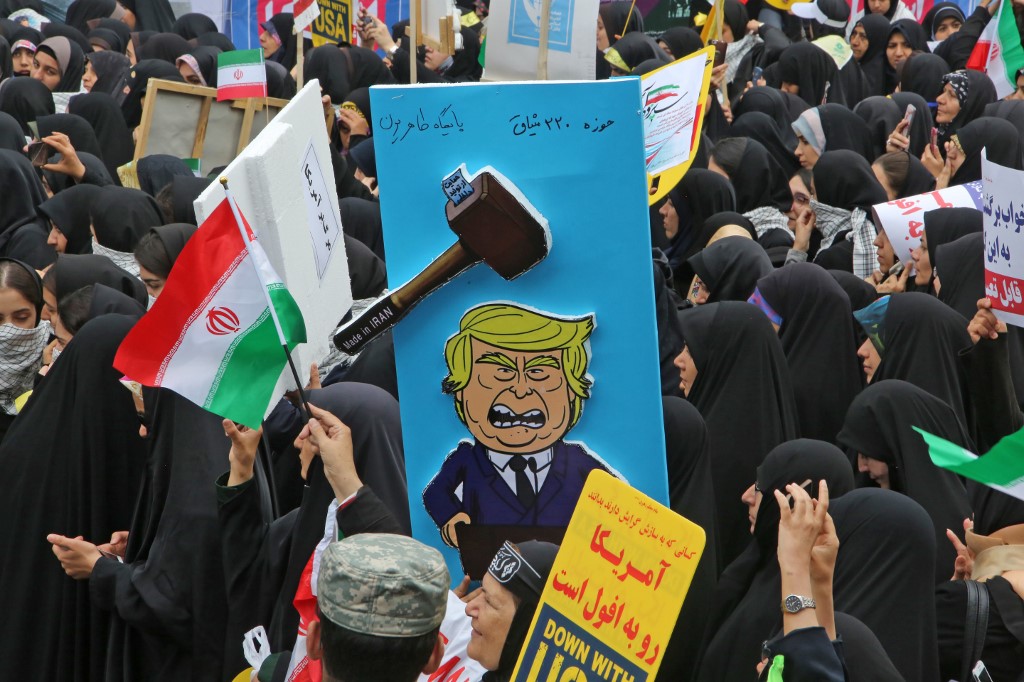 A placard mocks US President Donald Trump during a rally in Tehran on 4 November (AFP)