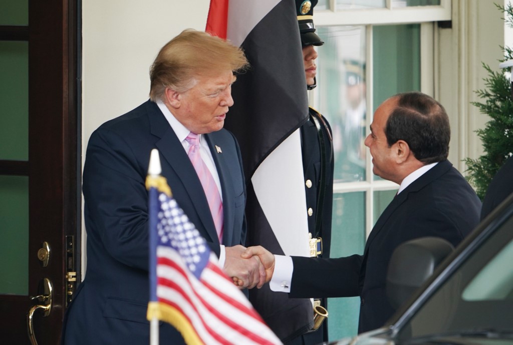 US President Donald Trump greets Egyptian President Abdel Fattah al-Sisi in Washington on 9 April (AFP)