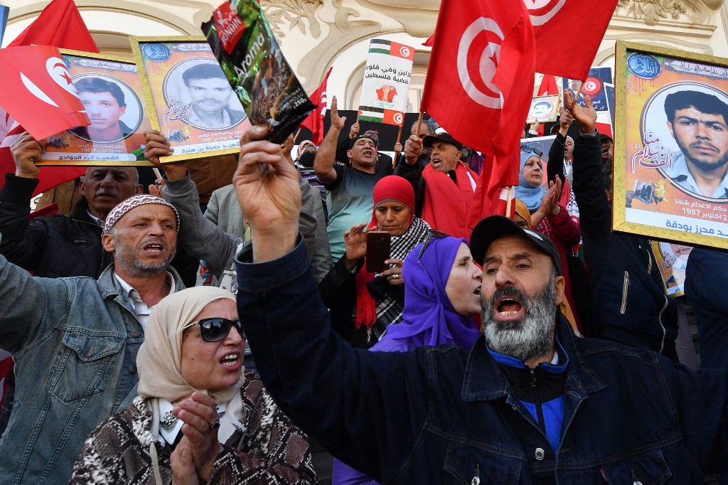 Tunisian demonstrators attend a rally against President Kais Saied, called for by the opposition "National Salvation Front" coalition, in the capital Tunis, on April 9, 2023.