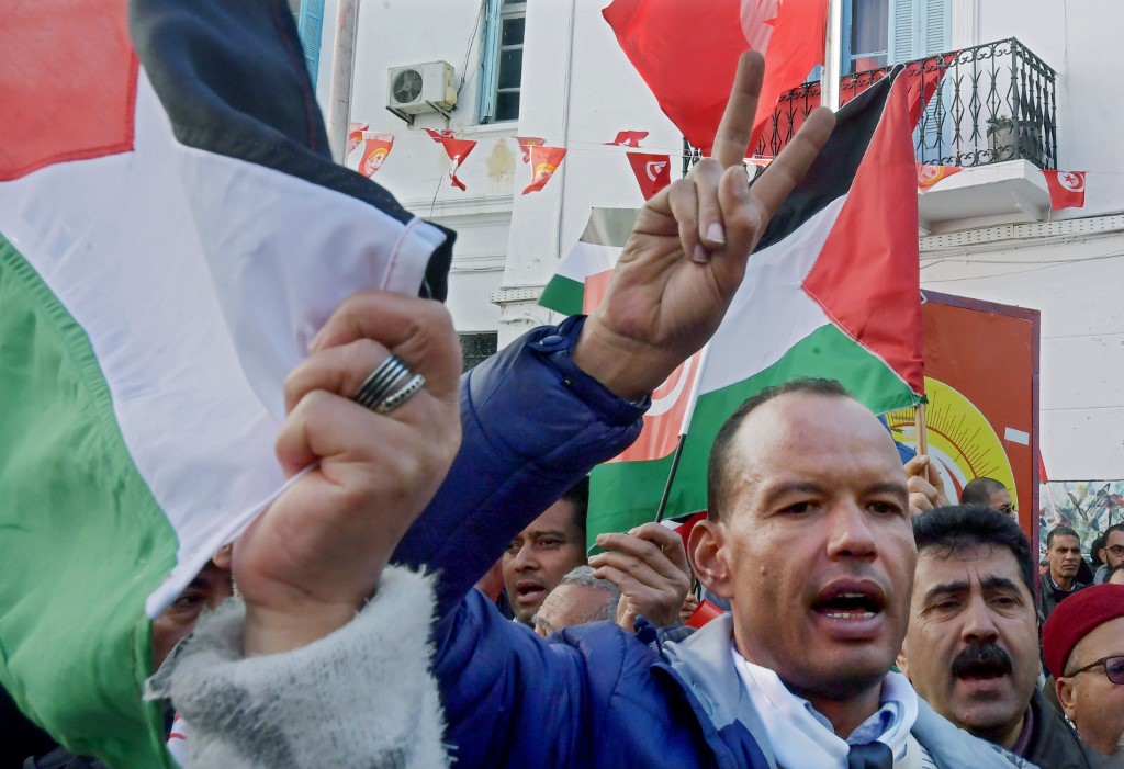 Demonstrators wave Palestinian flags during a protest against the US ‘deal of the century’ on 5 February in Tunis (AFP)