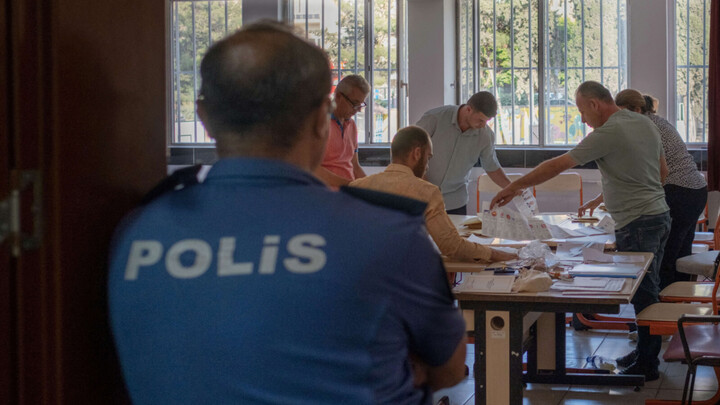 Election officials count ballots at a polling station in Antakya, Turkey, on 14 May (AFP)