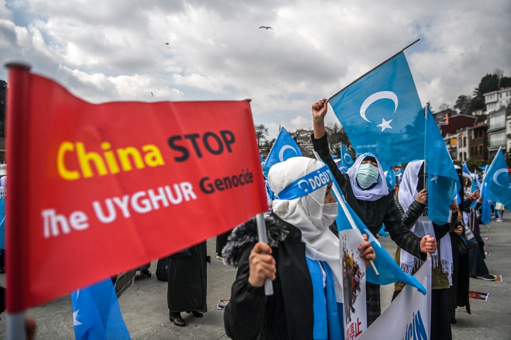 People protest China’s Uighur genocide in Istanbul on 8 March 2021 (AFP)