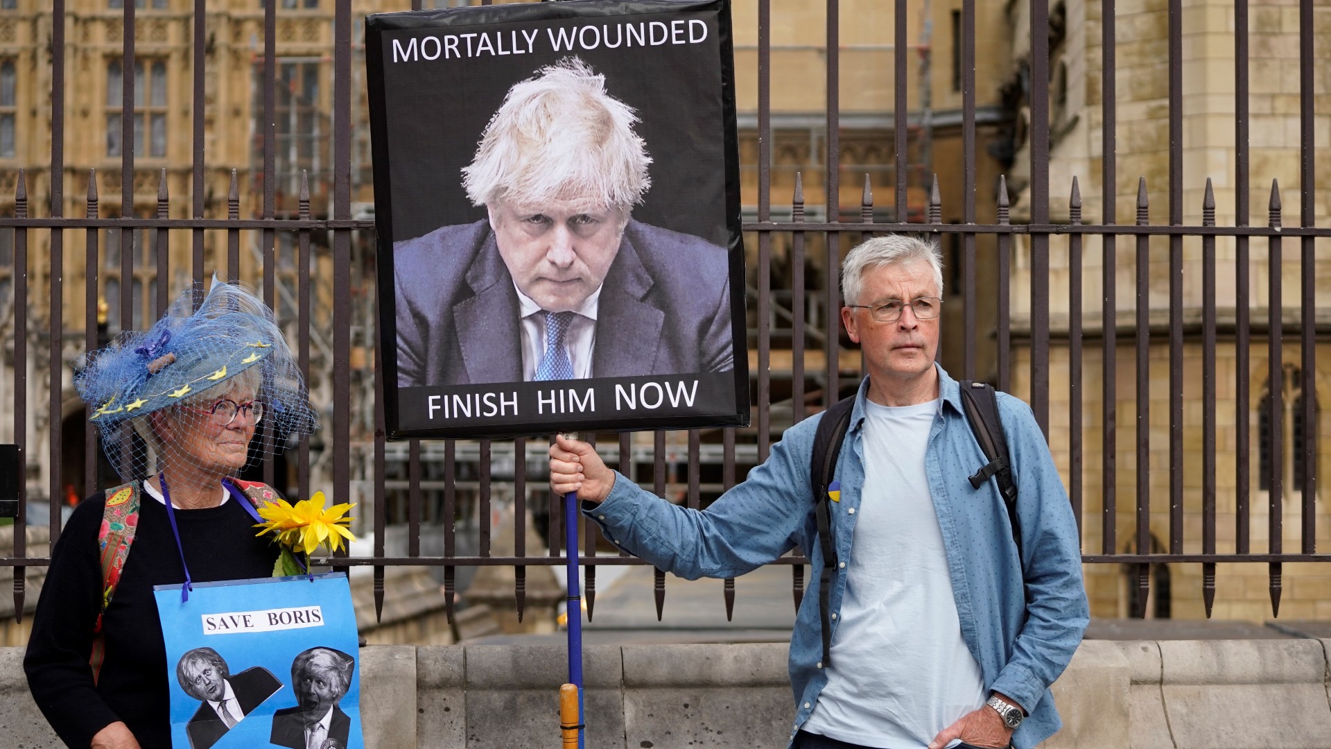 Demonstrators hold placards picturing Britain's Prime Minister Boris Johnson in front of The House of Parliament, in London, on June 6, 2022 