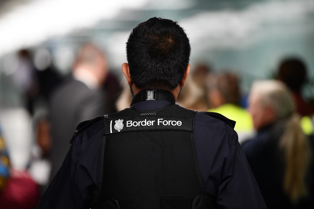 A UK Border Force member patrols at Heathrow Airport in London on 16 July (AFP)