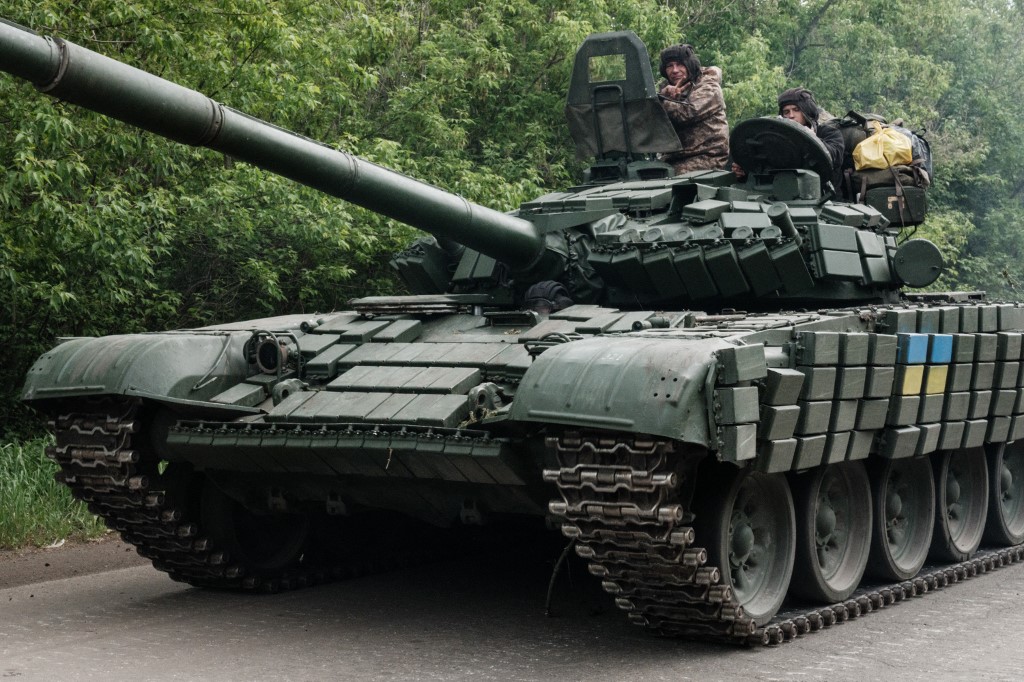 Ukrainian soldiers stand on a tank near Bakhmut on 15 May 2022 (AFP)