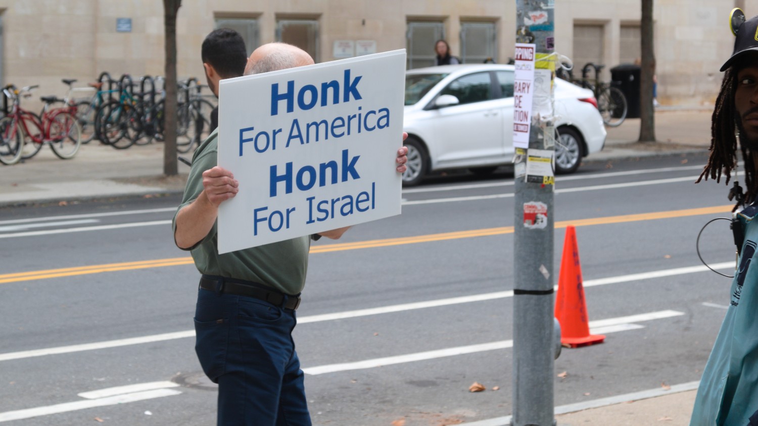 A man stands outside the Palestine Writes festival on 22 September 2023 holding a poster stating "Honk for Israel".