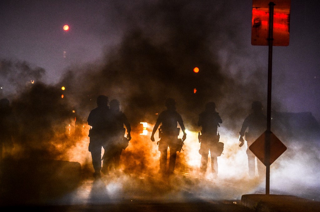 Police use tear gas to disperse protesters on 29 May during a demonstration in Minneapolis, Minnesota, over the death of George Floyd (AFP)